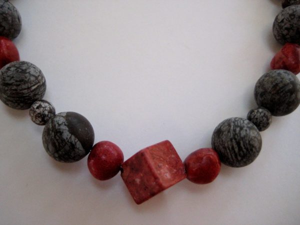 Fokus auf die roten Schaumkoralle-Steine der Edelsteinkette aus Koralle und Achat.